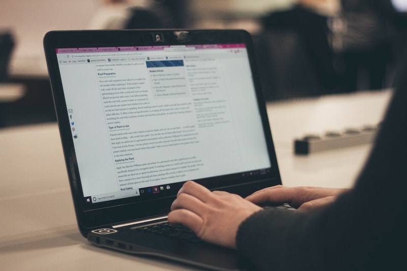 a person typing on a notebook